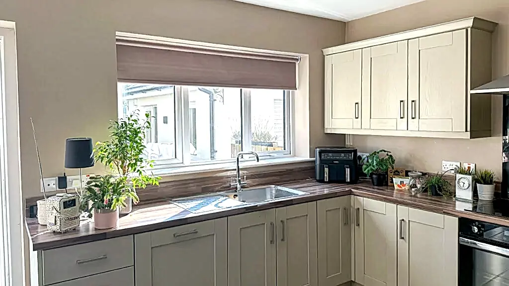 roller best kitchen blinds 2024 in a modern home northern ireland cream and wooden colours neutral earthy tones