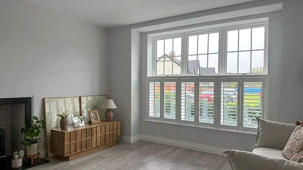 Composite Window Shutters in the Cafe Shutter style in a modern living room of a contemporary style mimimalist white new build home in northern ireland large front window